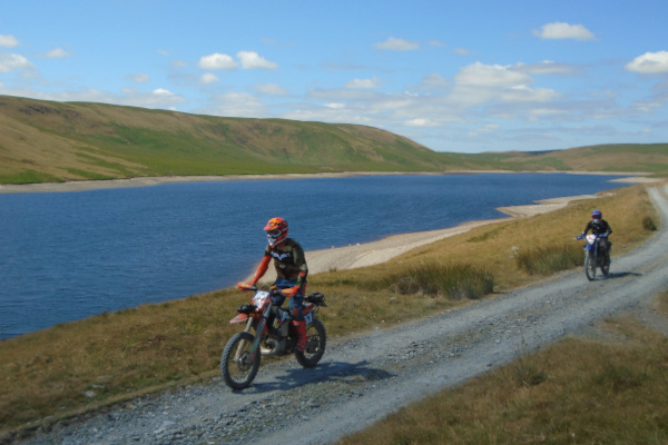 Trail riders in spring Trail riders in spring beside a reservoir