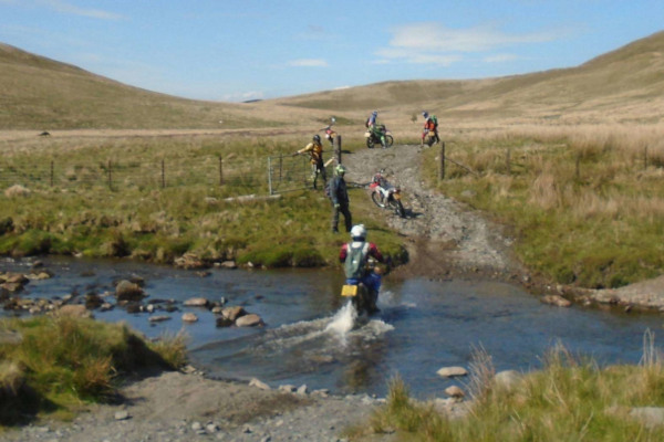 Trail riders crossing a river